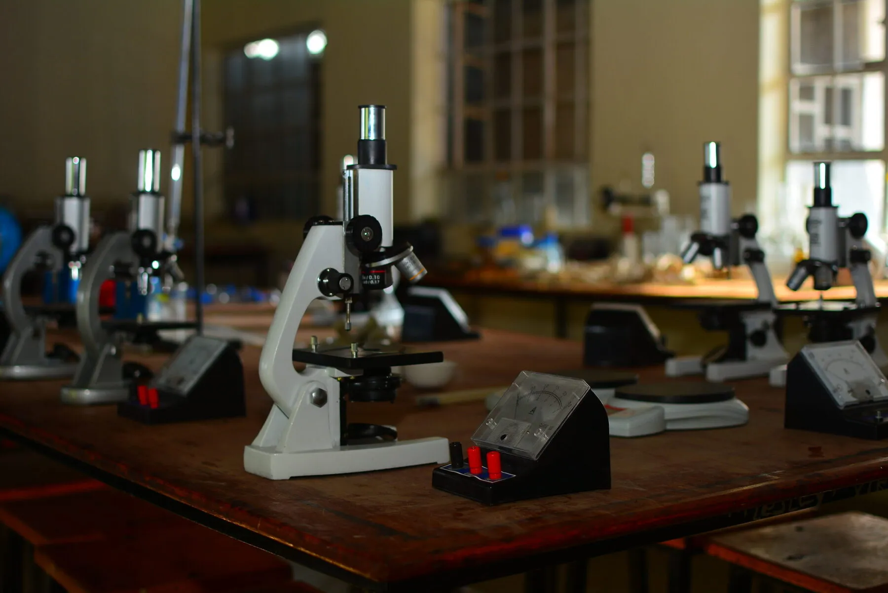 Microscopes set out on the benches in the science lab